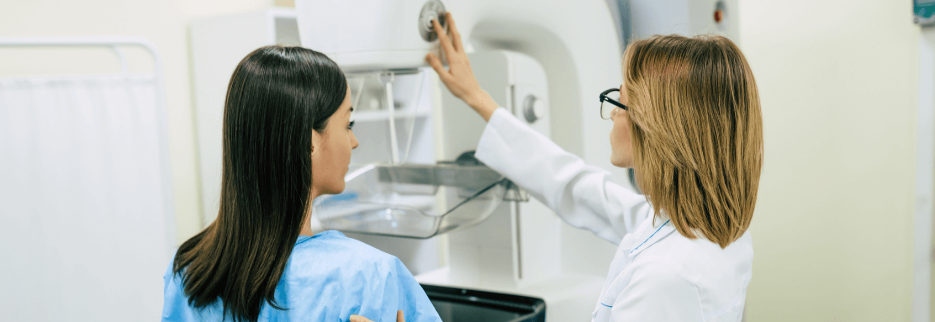 a woman in a white coat and glasses touching a machine