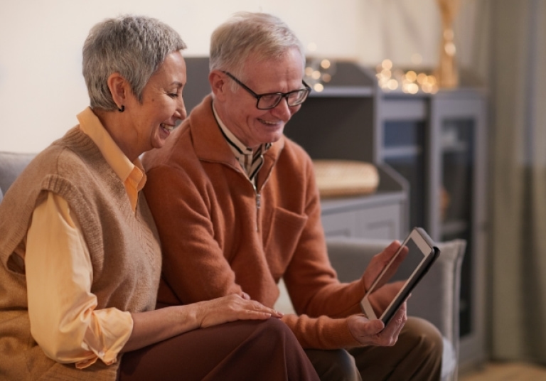 a man and woman looking at a tablet