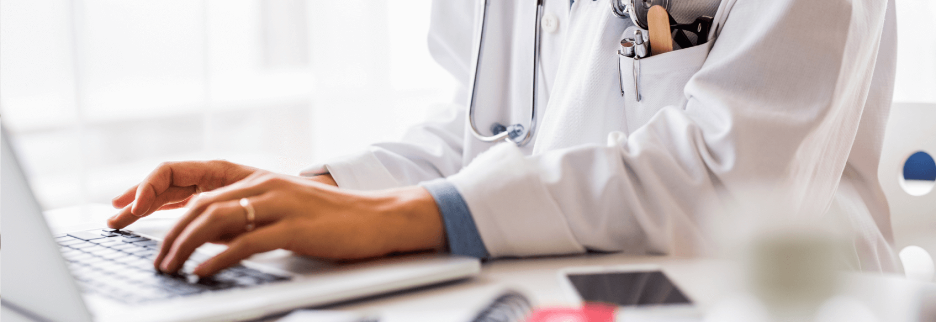 a close-up of a doctor's hand on a laptop