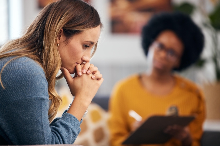 a person sitting with her hands on her chin