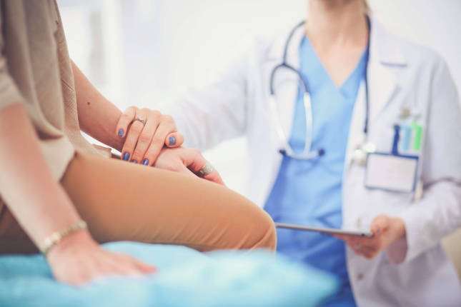 a doctor holding a patient's hand