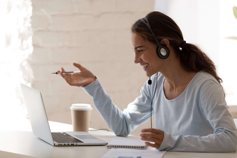 a woman wearing headphones and holding a pen