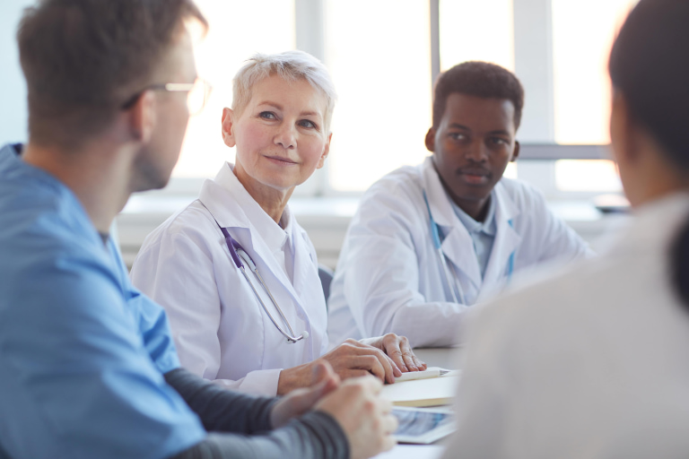 a group of people in white coats