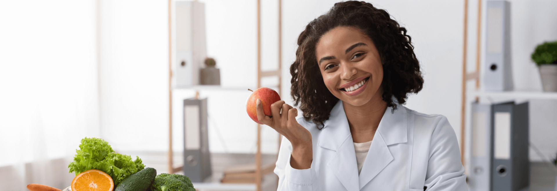 a woman holding an apple